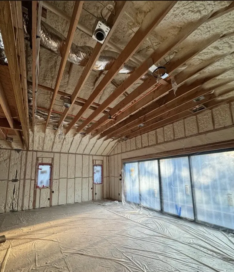 Interior walls and ceiling insulated with spray foam during new construction in Amherst